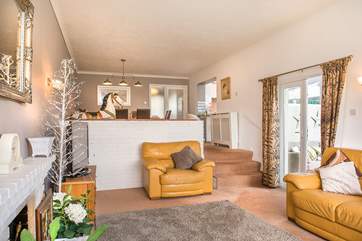The sitting-area, with steps leading down from the dining-area, from here you can access the conservatory.