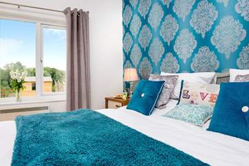 Bedroom 1 enjoys the view of the garden and open countryside.