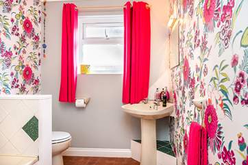 The family bathroom has a fitted shower and a bath.