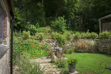The pretty garden is full of colour in the spring and summer.