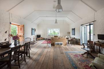 The spacious sitting-room is a fantastic, sociable and comfortable space flooded with light.