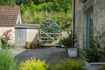 The gate at the far end of the courtyard next to the back door, leads to the recycling area.
