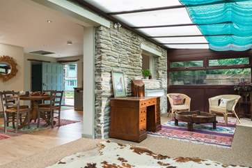 An open archway leads from the living-room to the big conservatory which overlooks the private garden.