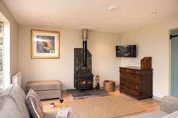 The wood-burner is perfect for cosy film nights snuggled up on the corner sofa.