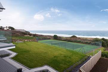 A view from the apartments across the gardens and the neighbours' tennis court to the beach beyond.