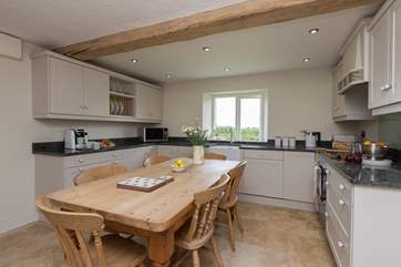 This is the brand new main kitchen with a welcoming farmhouse kitchen table perhaps for children to eat at whilst parents are cooking - there is also a proper dining room.