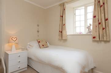 This is bedroom 5 - the single bedroom that links to bedroom 6. There are a couple of steps up to bedroom 6 and there is a door so that the single room can be used totally separately.