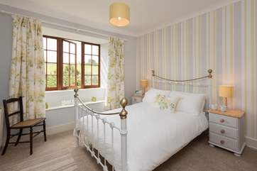 This is bedroom 4. A lovely double bedroom with a classic iron-framed bed.
