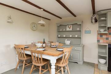 There is a farmhouse dining-table in one corner - in the meadow outside there are picnic tables for eating al fresco or for having a barbecue.