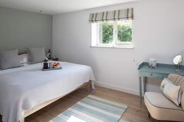Light pours in to this very stylish and spacious master bedroom.