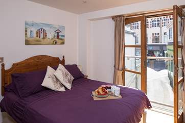 Master bedroom with Juliet balcony. Swing open the balcony doors to listen and watch the world pass by only a stone’s throw away.