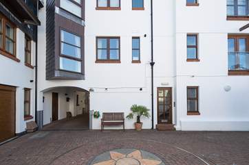 1 Pump Street Mews is accessed by the door to the right of the bench.
