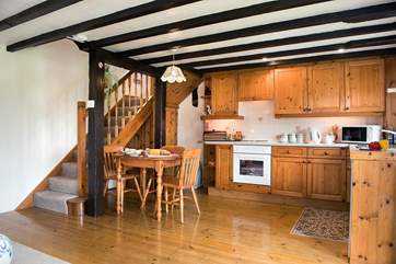 The open plan living-room on the ground floor - the kitchen has ample storage space and is well-equipped.