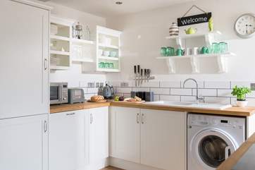 Touches of green on the kitchen shelves.