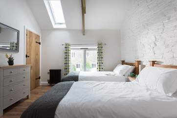 A floor to ceiling window and Velux roof window allow light to flood in during the day.