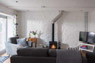 The wood-burner is a cosy focal point in cooler months.