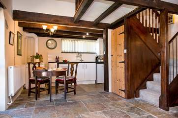 The stairs provide a natural divide between the kitchen and dining areas, and the sitting-area.