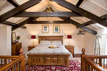 The bedroom has a bespoke hand-made bed.