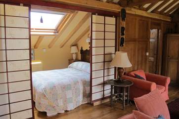 Bedroom 2 is set back just off the lounge behind these very attractive screens.