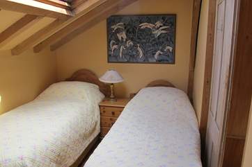 The compact yet comfortable twin room which has a en suite toilet and wash-basin.