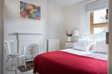 The pretty double bedroom with feature fireplace (Bedroom 3).