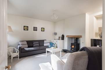This sitting-room with comfy seats around the cosy wood-burner.