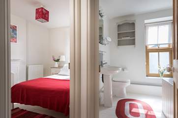 This bedroom is next to the bathroom.