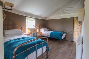 The lovely twin bedroom is located towards the back of the tent.