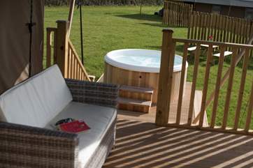 Steps lead down to the bubbling hot tub.