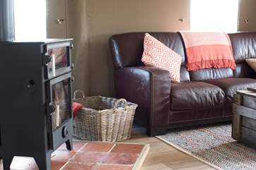 The spacious open plan living area comes complete with a cosy wood burnning stove that serves as an oven too.