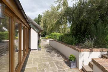 The path runs around the outside of the house - do take care of the steps and the drop from the garden if you have small children with you.