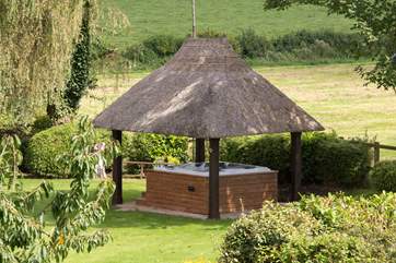 The hot tub in its pretty thatched pergola is a wonderful treat here.