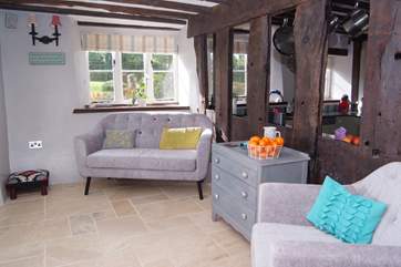 This is the snug - adjoining the kitchen with the historic beams of the farmhouse separating the two spaces.