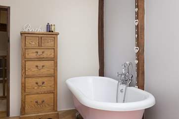 The family bathroom has a stunning roll top bath.