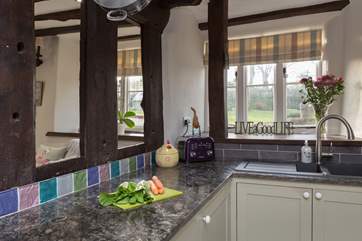 The kitchen area links to the snug through these ancient structural beams.