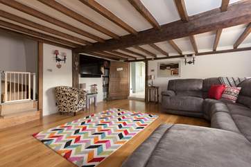 Another view of the main living-room. The stairs lead up to the first floor bedrooms and the stair-gate will help you to keep your four legged friends downstairs!