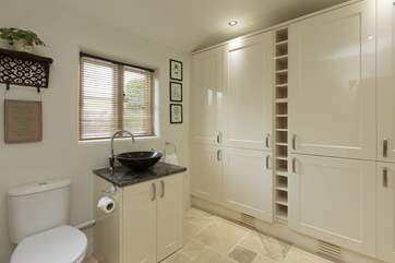The downstairs cloakroom also houses a super size fridge/freezer as well as additional storage.