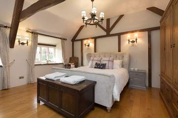 This is the master bedroom. A stunning high room with solid wood floors, high ceilings with beams and a brand new en suite shower-room.