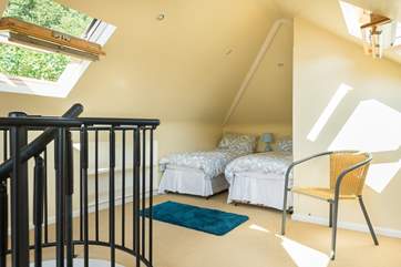 A spiral staircase leads up to Bedroom 4, which has three single beds (great dorm room for older children!).