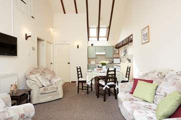 with high ceilings and beams the kitchen has a lovely country feel
