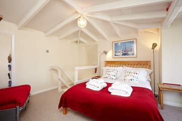 The master bedroom has vaulted ceilings and snuggle up in the arm chair to a good book