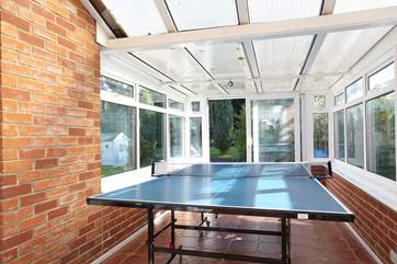 In the conservatory is a full-size table tennis table and games for the rainy days