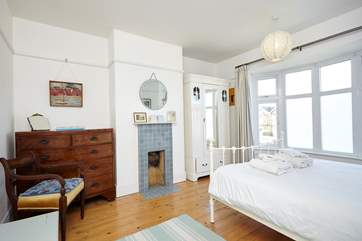 The master bedroom is complete with a tiled 1930s ornamental fireplace