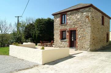 There is a spacious patio to the front and side of Nanteague Cottage, with a built-in barbecue.