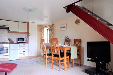 The glass-panelled stairs let light flood into the room.