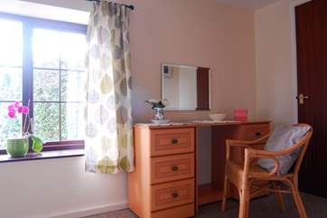 A lovely dressing area with walk-in wardrobe.