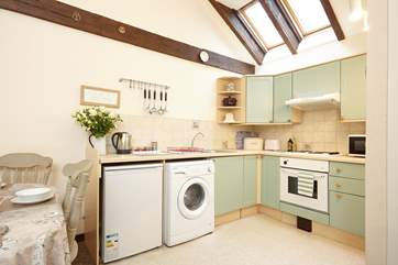 The kitchen has lovely high ceilings and wooden beams giving a lovely cottage feel throughout