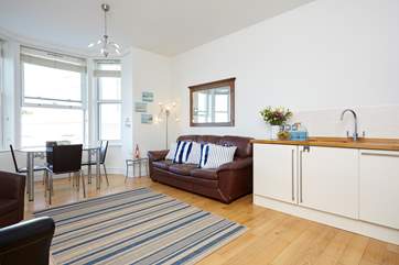 The open-plan space has high ceilings, wooden floor and large bay window with extensive sea view!