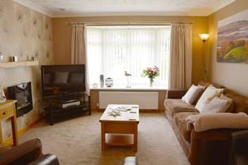 A large television and comfortable seating make it a perfect family sitting room.