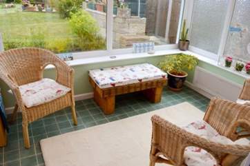 The conservatory is a lovely additional room to have your morning coffee looking out to the garden